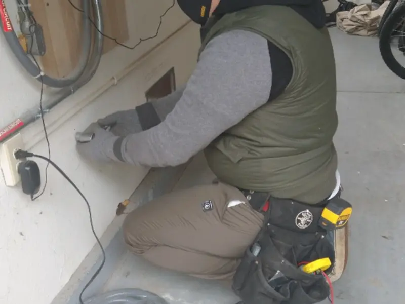 Electrician performing outlet wiring in a West Milford garage